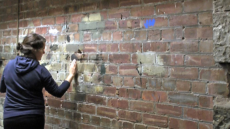 Su Grierson, Boiler room wall. Screen shot from 'Touchstone'.