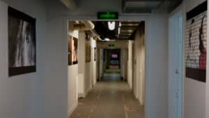 Su Grierson, Basement corridor with images and ‘Paysage’ on screen at Far end.