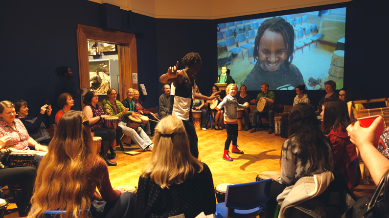 Su Grierson, Community Drumming & Movement event within the exhibition space.