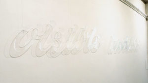 Su Grierson, Visible Invisible clear acrylic text made visible by light and reflection.